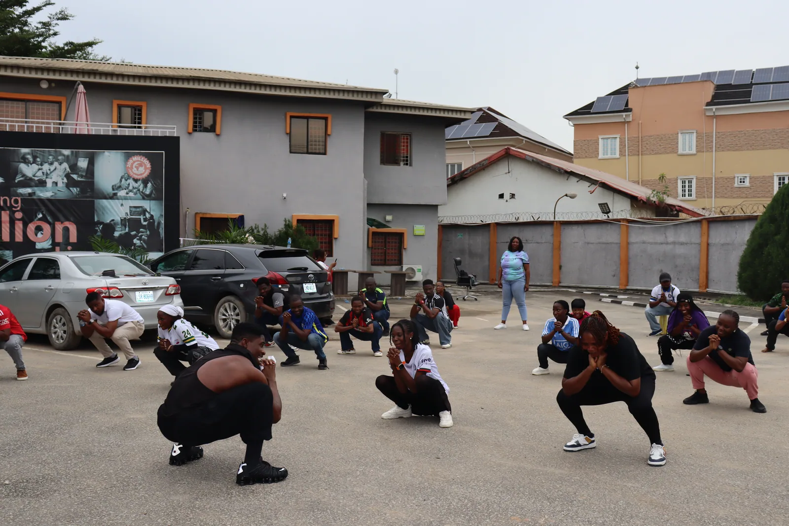 Colleagues exercise together in a courtyard.